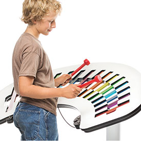 Boy playing on an outdoor playground xylophone 